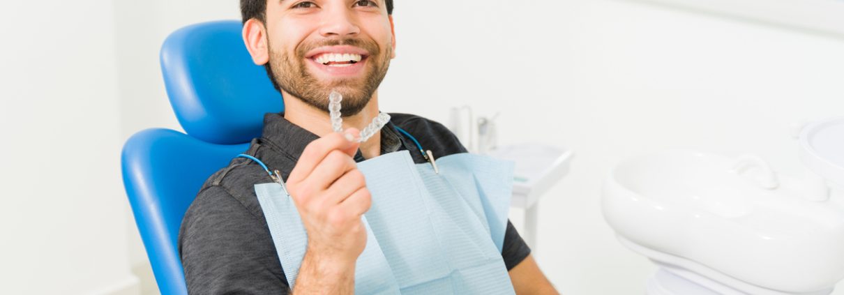 Close up of a happy man using invisible orthodontics